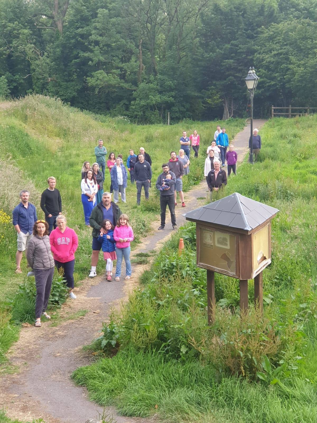 Local residents gather at site of sewage leak in public park